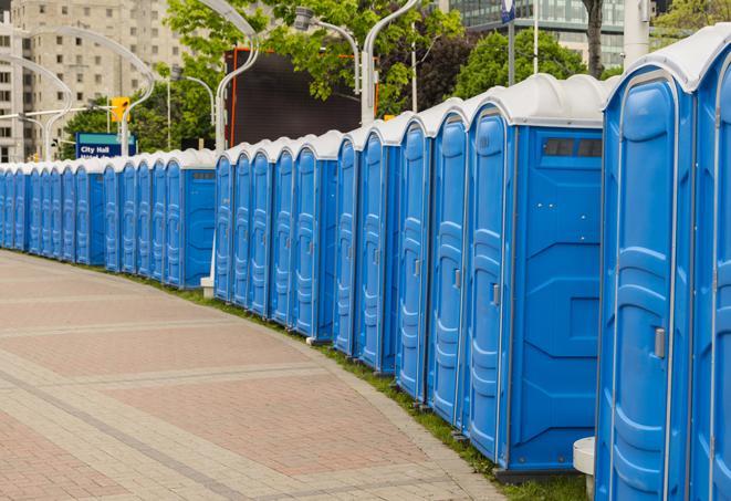 a row of portable restrooms set up for a large athletic event, allowing participants and spectators to easily take care of their needs in Georgetown